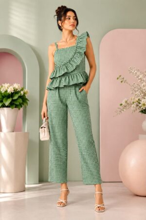 Green mini gingham ruffle co-ord set with sleeveless layered frill top and straight fit pants worn by female model against pastel background